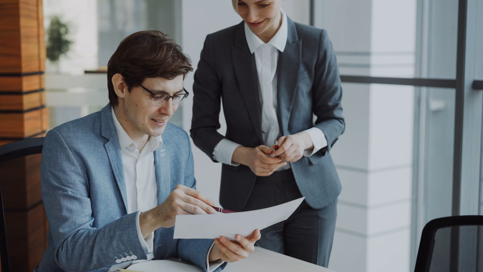 Two people discussing a paper conract