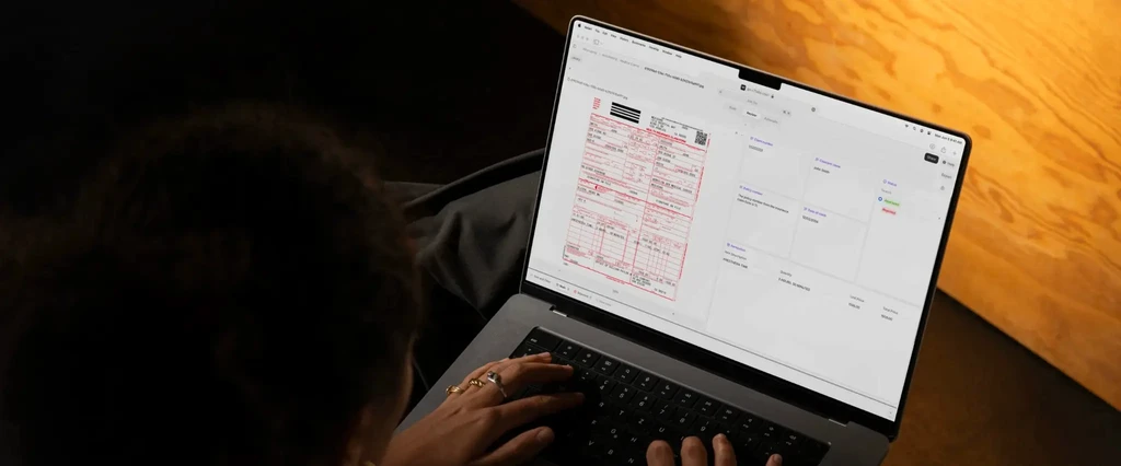 Laptop open showing a medical claim form and summary data.