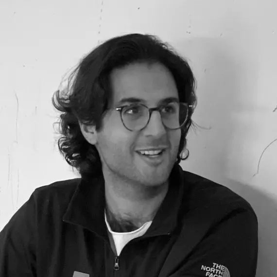 Man in glasses, wearing a jacket.