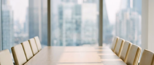 Empty conference room with table and chairs, blurred city view