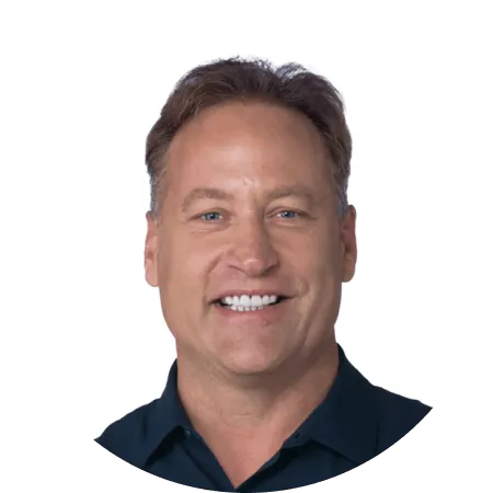 Smiling man with short brown hair in a dark shirt.