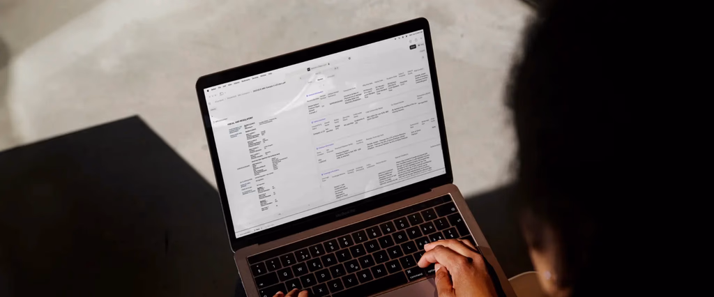 Laptop screen showing financial and regulatory information.