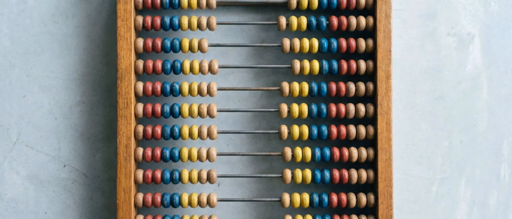 Wooden abacus with red, blue, and yellow beads.