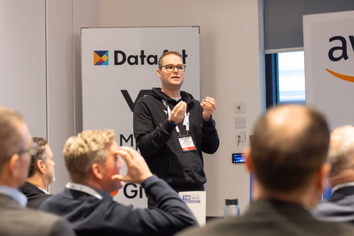 Man speaking at event with audience