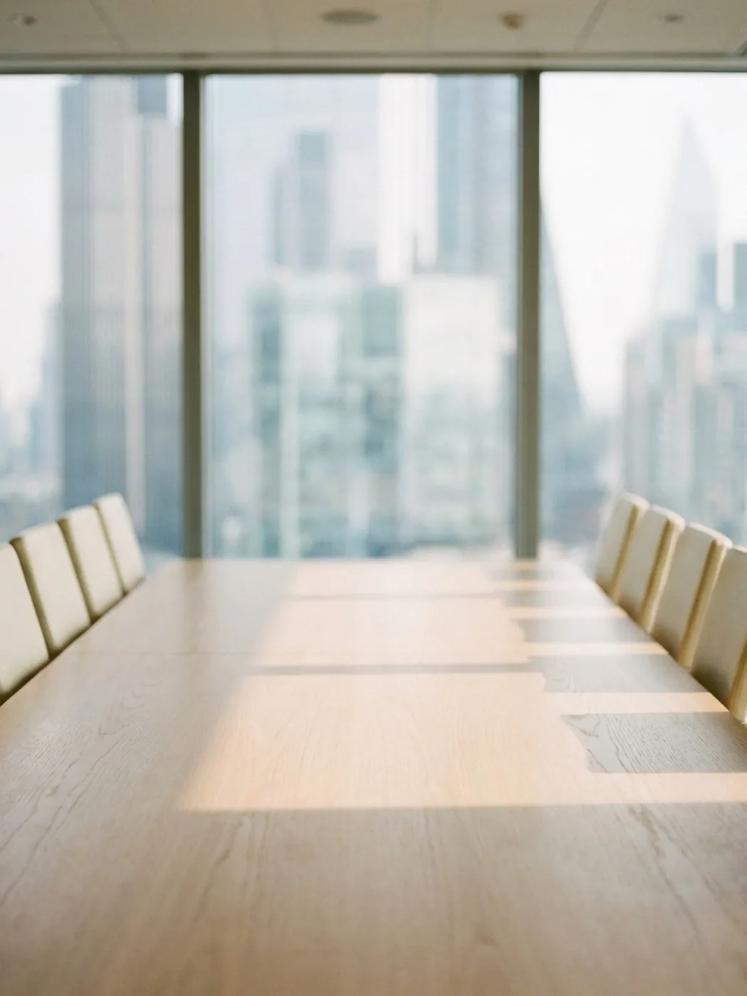 Boardroom table with chairs and city view