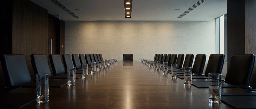 Empty boardroom with many chairs and glasses.