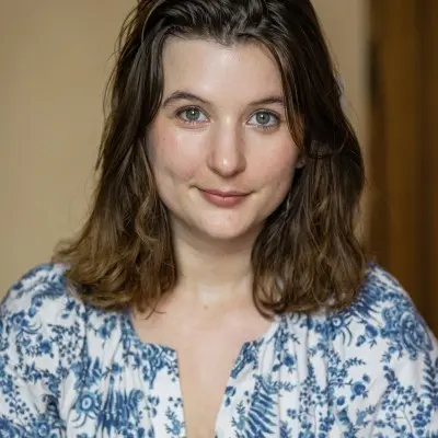 Woman with brown hair and blue shirt