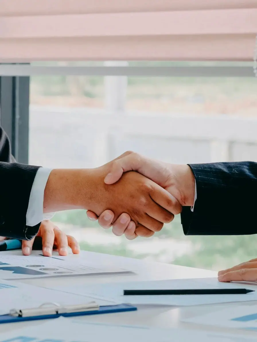 Business handshake over documents