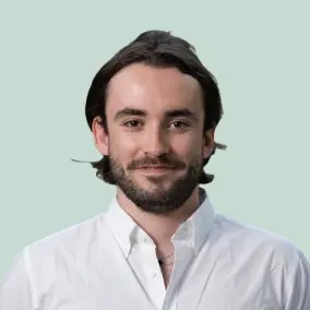Man in white shirt with beard and long hair