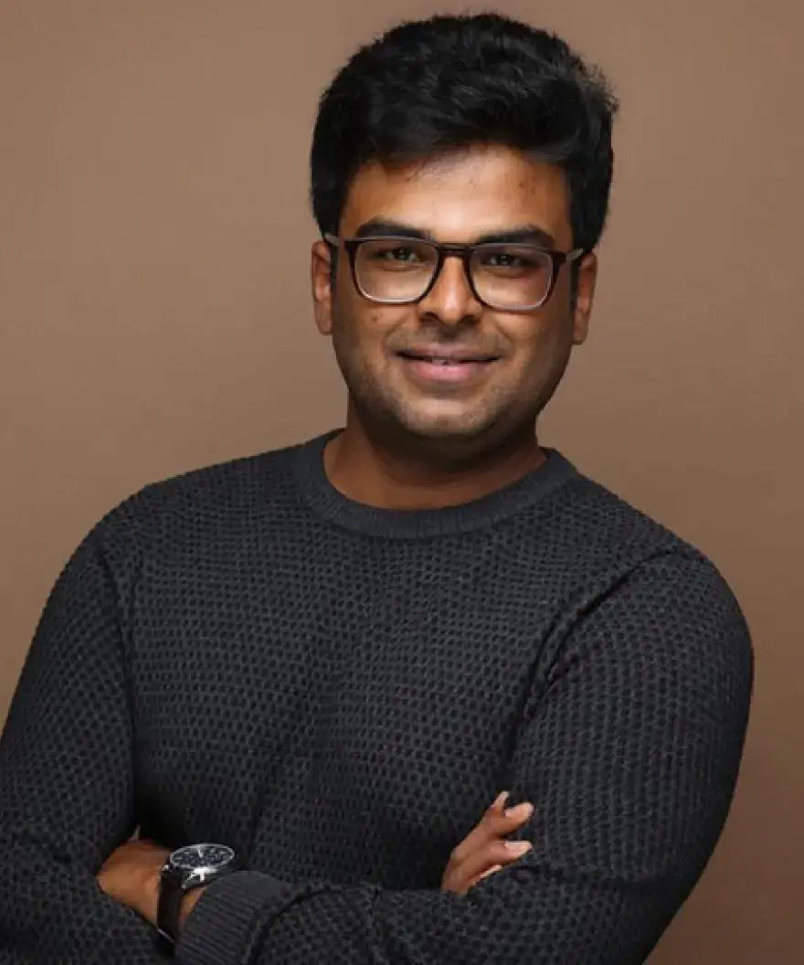 Man with glasses and arms crossed.