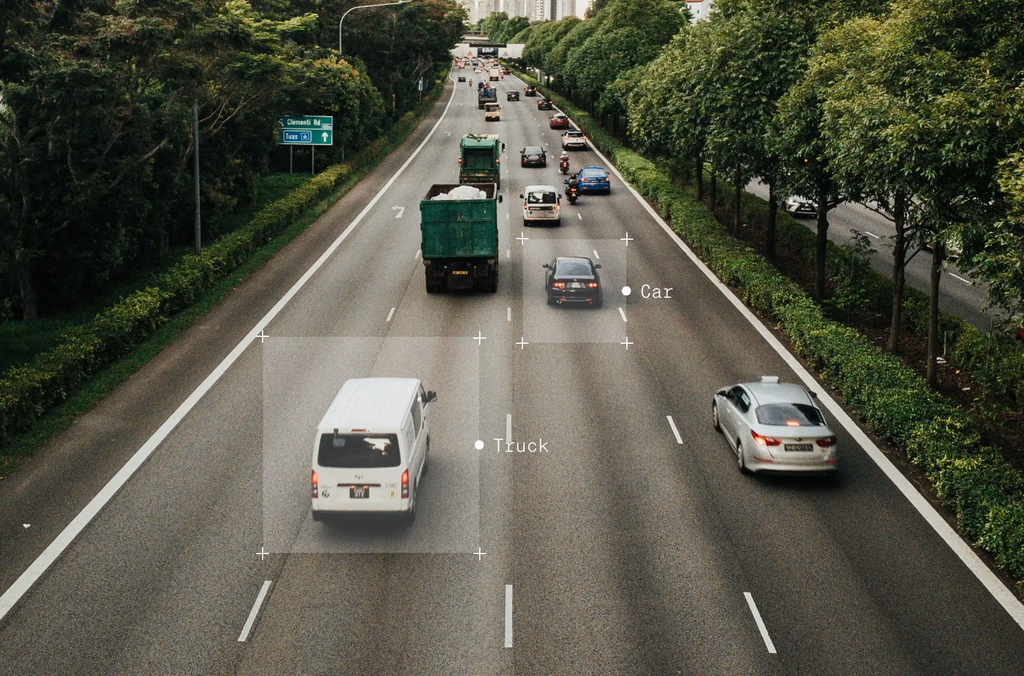 Vehicles on a highway, with car and truck labels.