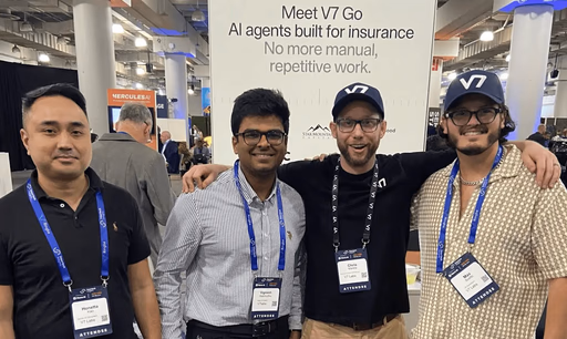 Four men posing in front of a Vinsys G.O. banner.