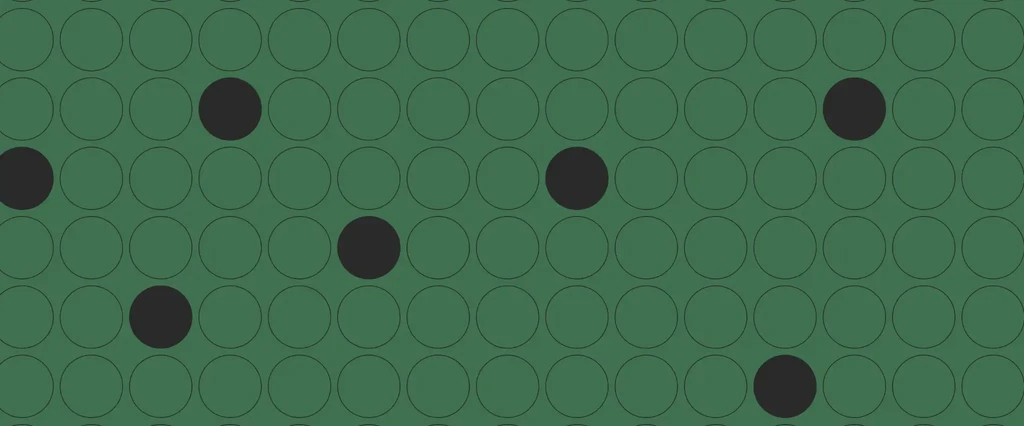 Black circles on a green grid.