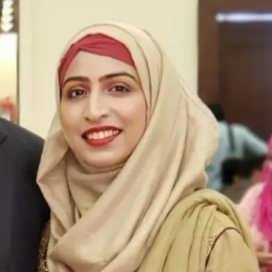Woman in beige hijab and red headscarf smiling
