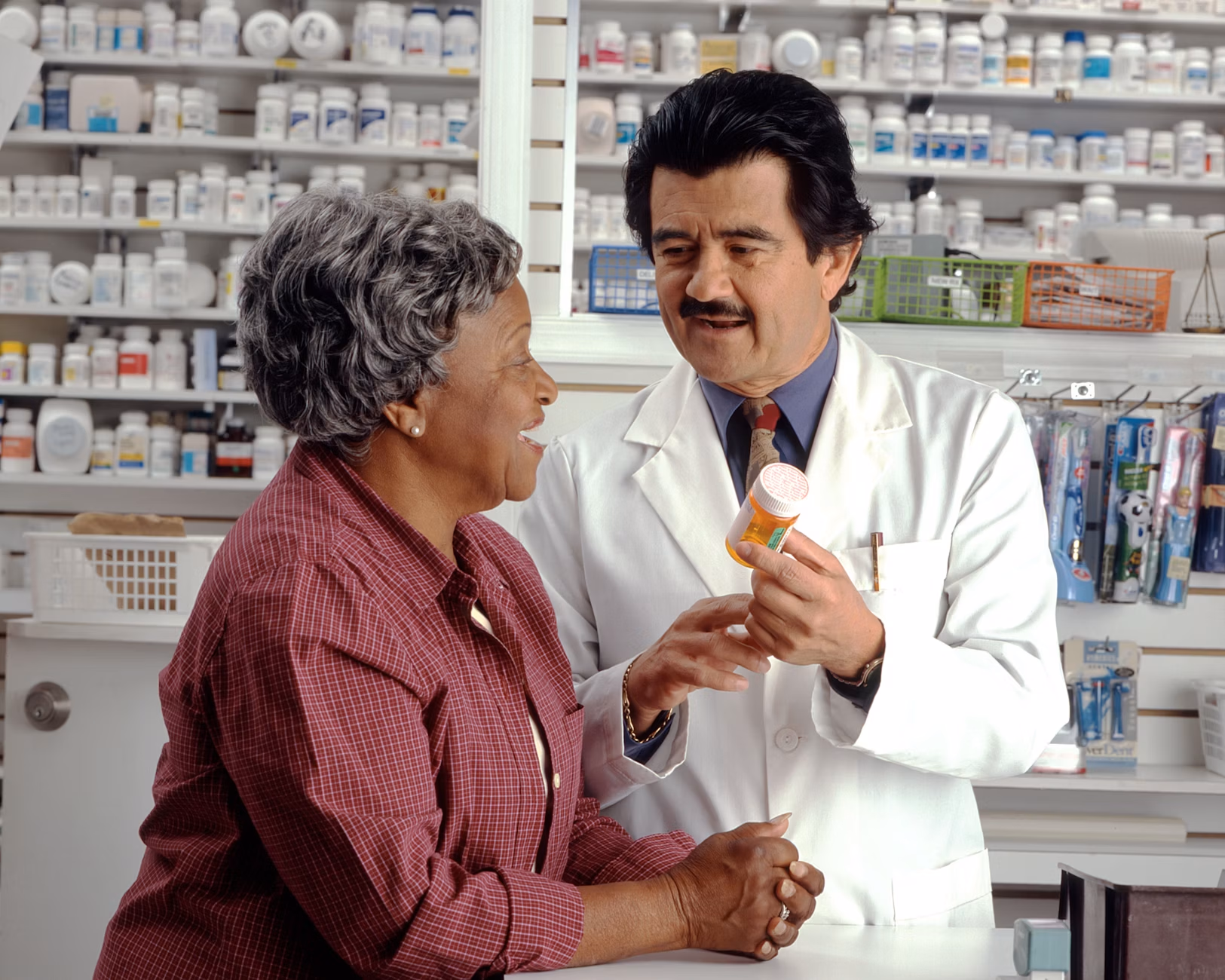Image of pharmacy with pharmacist helping woman