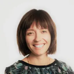 Woman with short brown hair and a floral top.