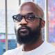 Bald man with beard and glasses.