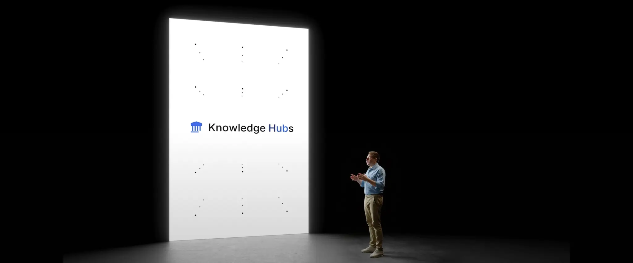 Man speaking in front of a large screen with "Coverage hubs" logo