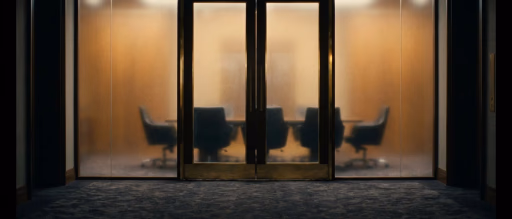 Frosted glass doors revealing a conference room with chairs.