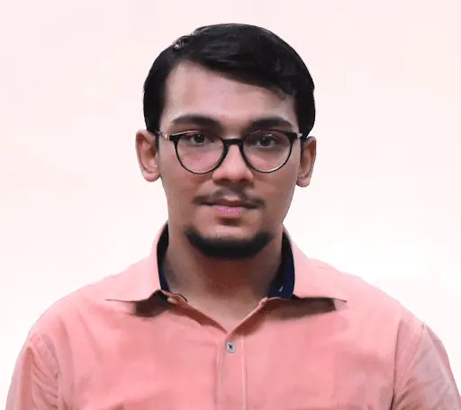 Man in peach shirt and glasses.