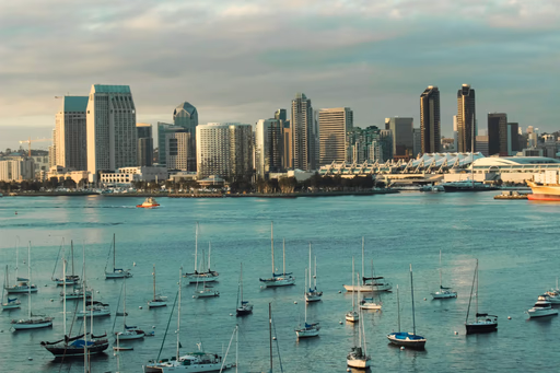 Wide shot of San Diego skyline with sailboats.